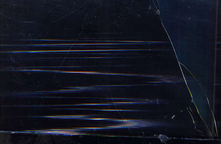 Broken glitched screen. Fractured texture. Dark scratched laptop display with digital noise.