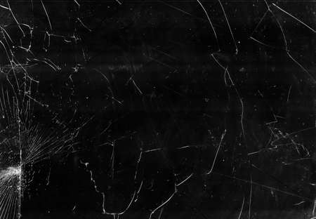 Broken window glass. Fractured texture. Black crashed computer screen with white dust scratches.の写真素材