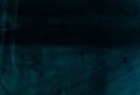 Dust scratches overlay. Stained texture. Teal blue faded surface with smeared dirt effect.の写真素材