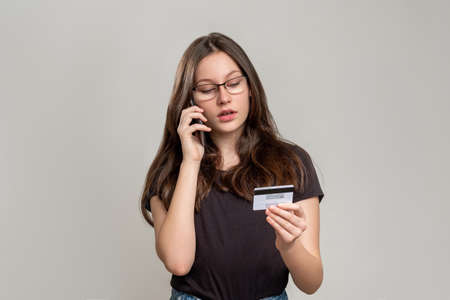 Confident woman portrait. Female power. Strong smart lady in eyeglasses isolated on gray background. Feminism protest. Skeptic activist. Gender equality.の写真素材