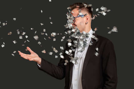 Business trick. Fraud scheme. Fooled man in suit got confetti puff in face isolated on black. Disappointed guy portrait. Professional scam. Silly joke.の写真素材