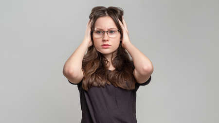 Confident woman portrait. Female power. Strong smart lady in eyeglasses isolated on gray background. Feminism protest. Skeptic activist. Gender equality.の写真素材