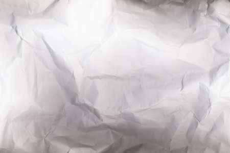 Crushed paper background. Crinkled texture. Blank white old crinkled surface.の写真素材