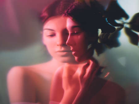 Art portrait. Feminine beauty. Sensual woman face blur silhouette in floral pattern neon red light double exposure. Wellness harmony. Peaceful mind. Nostalgic melancholy. Soul elegance.の写真素材