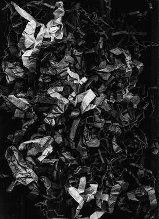 Rough abstract background. Crumpled texture. Black white shredded paper composition.の写真素材