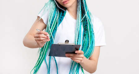 Z generation woman with bright blue hair braids working on project. Confident lady with creative...