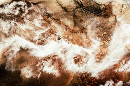 Marble texture art background. Ink water. Brown mineral stone creative pattern. Aerial mountain rock in white clouds abstract design. Land vein surface.の写真素材