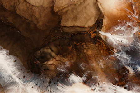 Marble texture. Acrylic ink water. Brown white natural mineral stone design art background. Creative abstract gold fleck sand land rock with streak pattern. Luxury stained surface.の写真素材