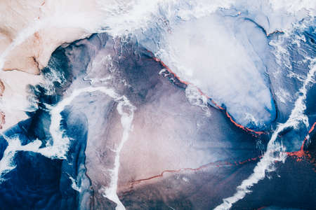 Marble texture. Acrylic ink water. Blue ocean waves sand land abstract design with white clouds effect. Natural mineral stone grain streak pattern with orange fleck veins. Luxury art background.の写真素材