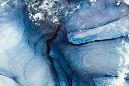 Blue marble art background. Alcohol ink water. Frozen grain sparkles texture surface with white wave...