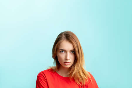 Shocked woman portrait. Special offer. Overwhelmed lady in red with nude makeup looking at camera...