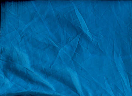 Aged abstract background. Wrinkled fabric texture. Blue crushed textile.の写真素材