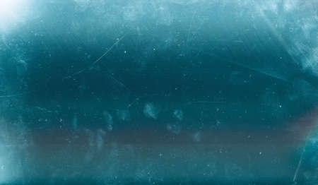 Scratched ice background. Aged glass texture. Teal blue old window effect overlay with dust.の写真素材