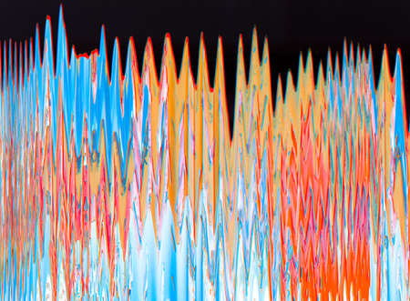 Colorful glitch art. Distortion noise. Orange blue defect on black dust abstract background.