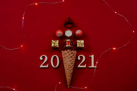 Happy New Year 2021. Abstract Christmas tree arrangement, LED string lights and numbers on maroon...