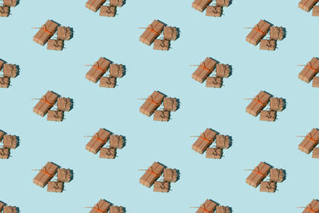 Present pattern. Blue seamless background. Gift delivery. Holiday congratulation. Minimalist composition of rustic beige recycled paper box pile isolated on light.の写真素材