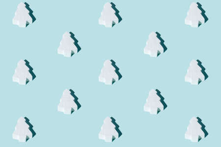 Christmas tree pattern. Blue seamless background. Winter holidays decor. Festive symmetrical...