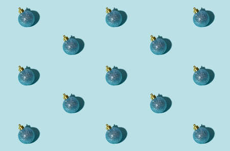 Blue Xmas background. Bauble seamless pattern. Winter holidays decor. Festive adornment. Round shiny glitter ball minimalist composition isolated on light.の写真素材