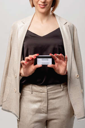 Bank loan. Business investment. Cashless payment. Cheerful female manager showing credit card...