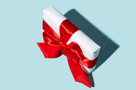 Holiday surprise. Anniversary present. Gift delivery. Festive reward. Present wrapped in white box...