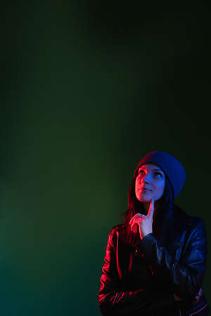 Neon light portrait. Curious woman. Night lifestyle. Thoughtful lady in red blue glow wondering...