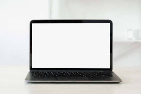 Laptop blank screen. Office workspace. Digital technology. Portable computer with empty monitor on white desk light background copy space.の写真素材
