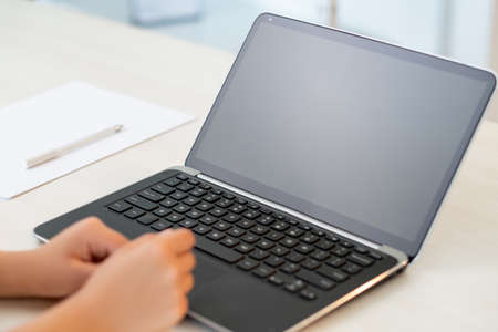 Online business. Freelance work. Remote job. Distance communication. Female hands laptop with empty screen on home office light workplace.の写真素材