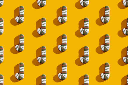 Orange seamless background. Christmas cane pattern. Winter holidays ornament. Striped white green...