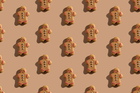 gingerbread man pattern. Christmas bakery decor. Festive cookies. Biscuit figures with colorful...