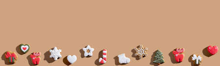 Beige New Year advertising background. Cookie decor. Winter holidays bakery food ornament. Gingerbread dessert minimalist composition isolated on light brown copy space.の写真素材