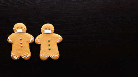 Pandemic conceptual background. Covid-19 quarantine. Hygiene measures. New normal. Two gingerbread...