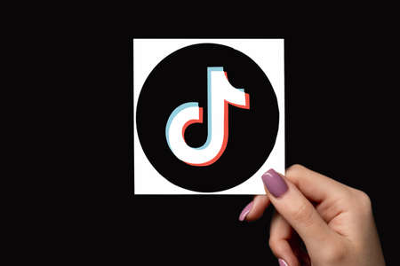 Kharkiv, Ukraine - June 05, 2020: TikTok logo. Social media. Online entertainment. Female hand...