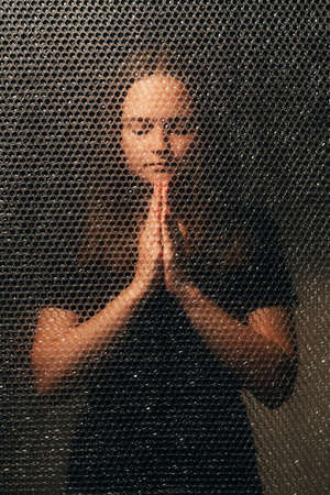 Praying woman. Sin confession. Spiritual practice. Hope faith. Textured portrait of peaceful...