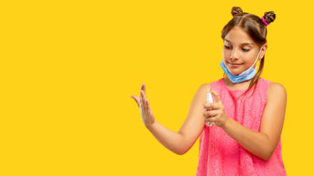 Hand disinfection. Covid-19 hygiene. Quarantine measures. Portrait of cheerful young girl in face...