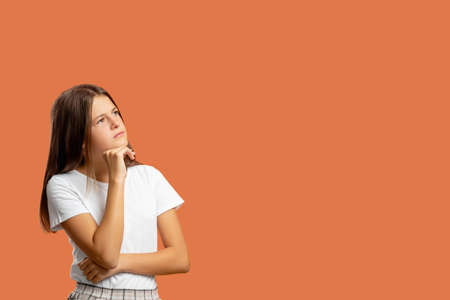 Pensive child. Commercial background. Hard choice. Inspiration idea. Portrait of doubtful puzzled...