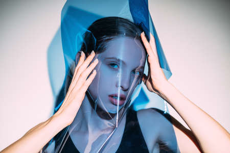 Beauty art. Fashion photography. Glamour look. Makeup cosmetology. Sensual female model covering...
