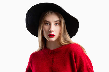 Hipster style. Trend look. Fashion model. Female elegance. Beautiful woman in red sweater black...