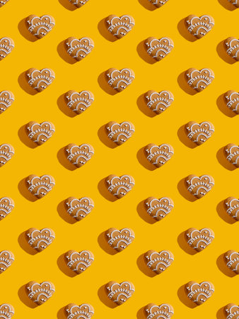 Heart pattern. Orange seamless background. Valentine Day. Romantic greeting card. White beige love symbol design ornament minimalist symmetrical composition isolated on bright yellow.の写真素材