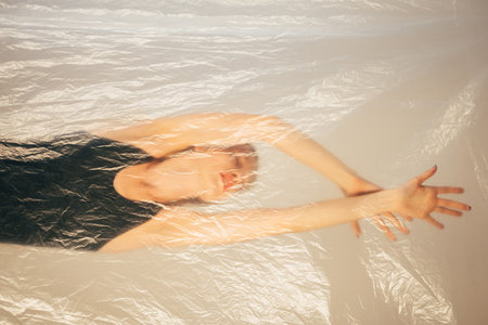 Defocused art portrait. Swimming sport. Active lifestyle. Sensual blonde athlete woman in black...