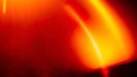 Colorful abstract background. Lens flare. Blur radiance. Sun beams. Red orange defocused light...