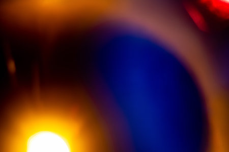 Colorful art background. Blur glow. Lens flare. Solar system. Orange blue defocused light refraction flecks on dark creative abstract banner with copy space.の写真素材