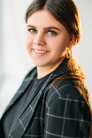 Successful woman portrait. Female leadership. Positive attitude. Portrait of cheerful confident enthusiastic smart business lady smiling on light background.の写真素材