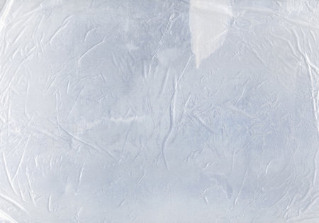 Wrinkled overlay. Wet paper creased texture. White scratched stained crushed transparent plastic polyethylene film. Weathered crumpled design background.の写真素材