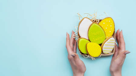 Easter holiday. Festive food decor. Sweet homemade ornament. Bright green yellow gingerbread cookie...