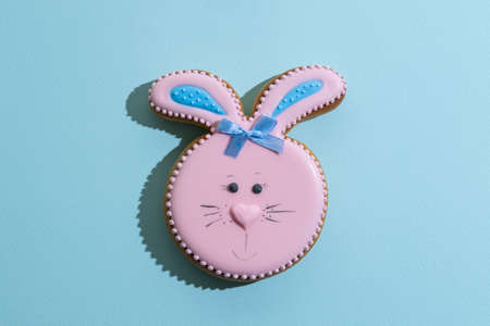 Easter bakery. Festive pastry. Traditional holiday gift. Pretty bunny gingerbread figure with pink...