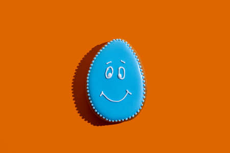 Happy easter bakery. Traditional gingerbread. Festive decoration. Pretty cookie figure egg with blue...