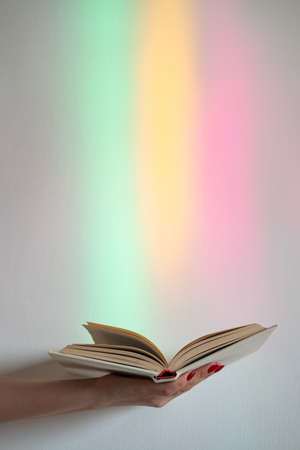 Opened book. Available knowledge. Enjoy study. Erudition new information. Female hand with story...