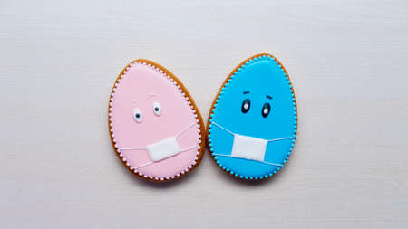 Pandemic composition. Easter holiday. Social distancing. Festive pastry decoration. Pink blue...