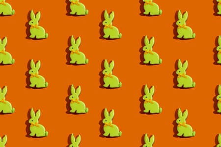 Pretty rabbit gingerbread cookies with yellow icing isolated on orange.の写真素材