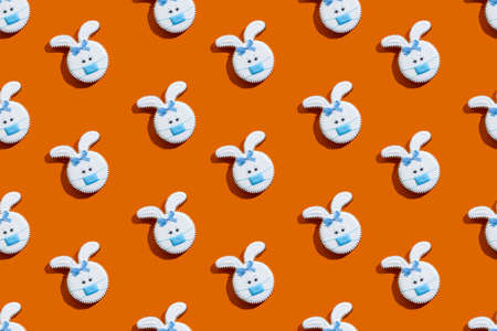 Bunny gingerbread cookies white icing medicine mask ornament isolated on orange.の写真素材